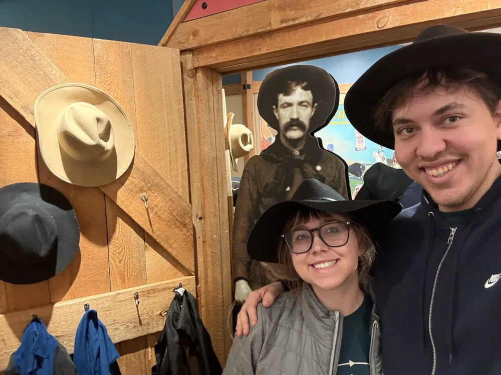 Austin Ellis and his wife wearing cowboy hats during the APS trip