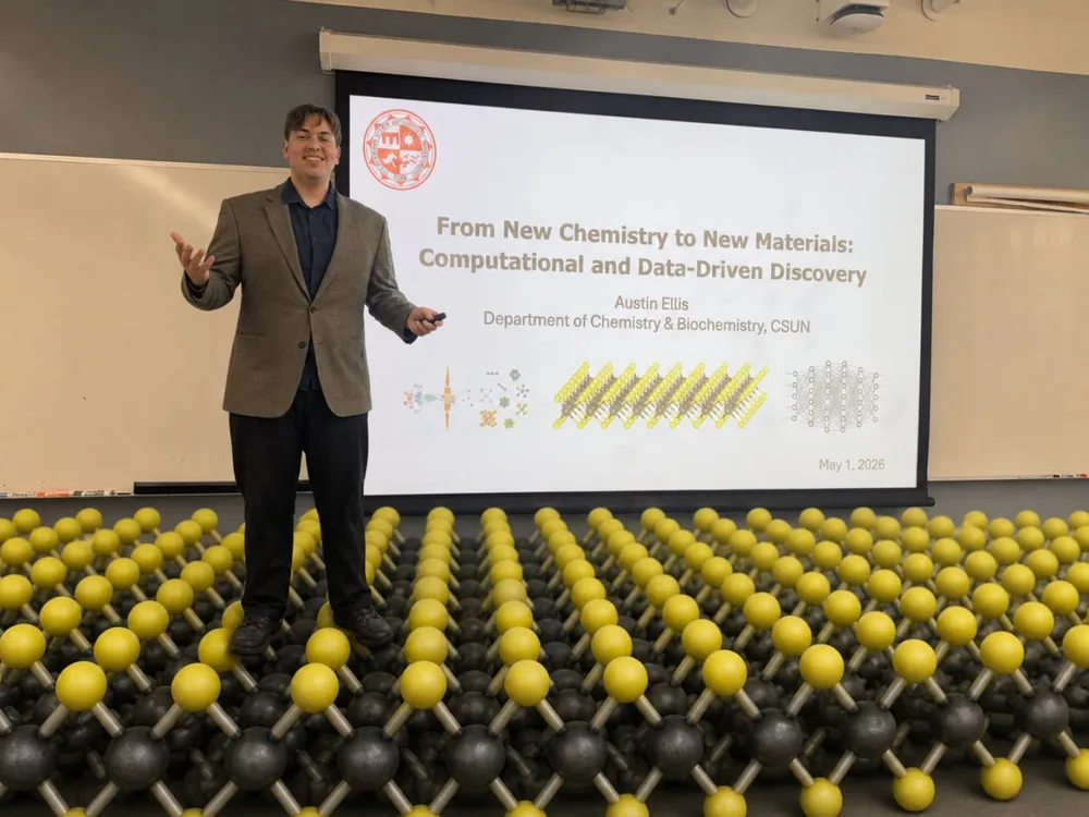 Austin Ellis standing in front of his M.S. thesis defense title slide at CSUN