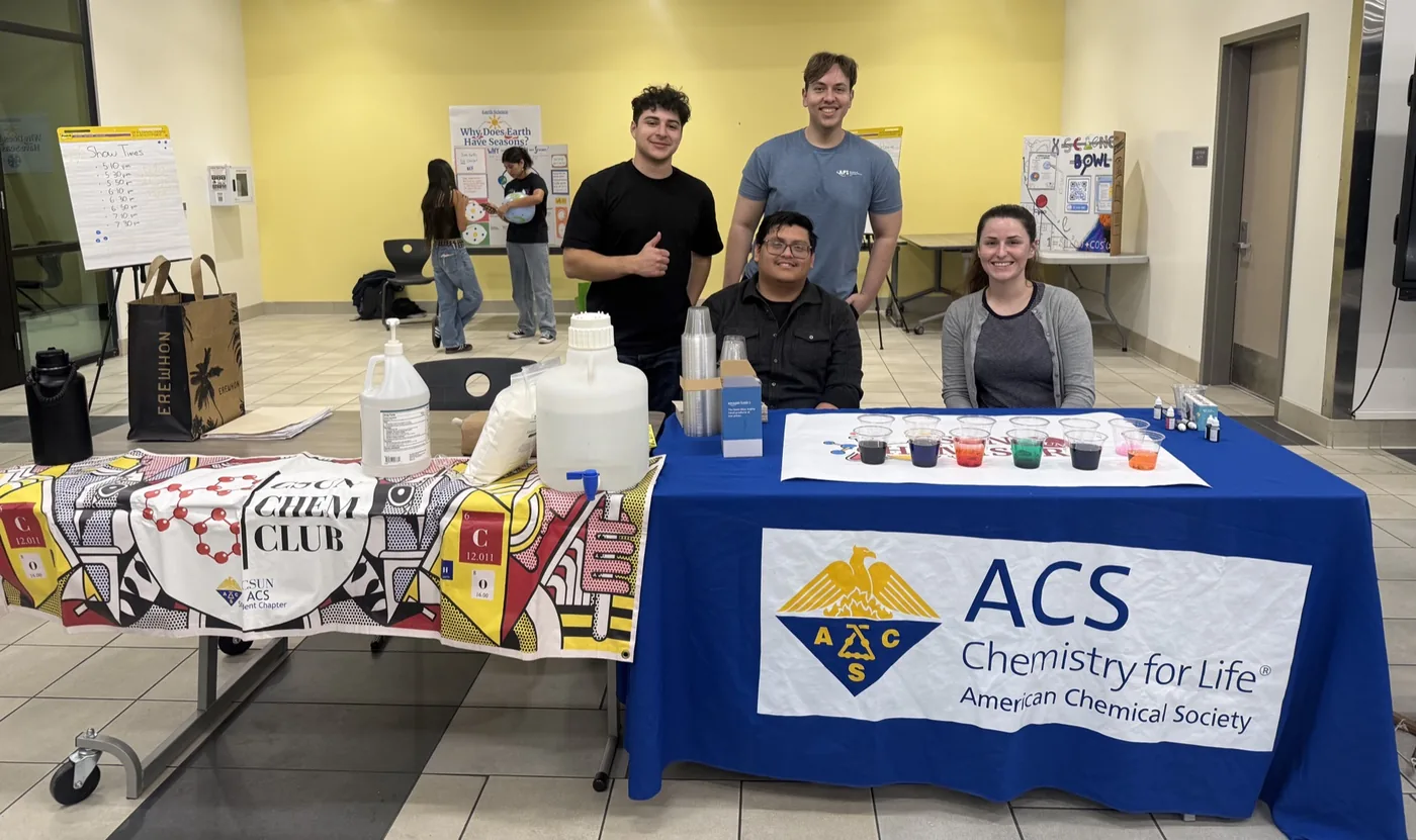Austin and fellow students hosting a hands-on chemistry outreach table