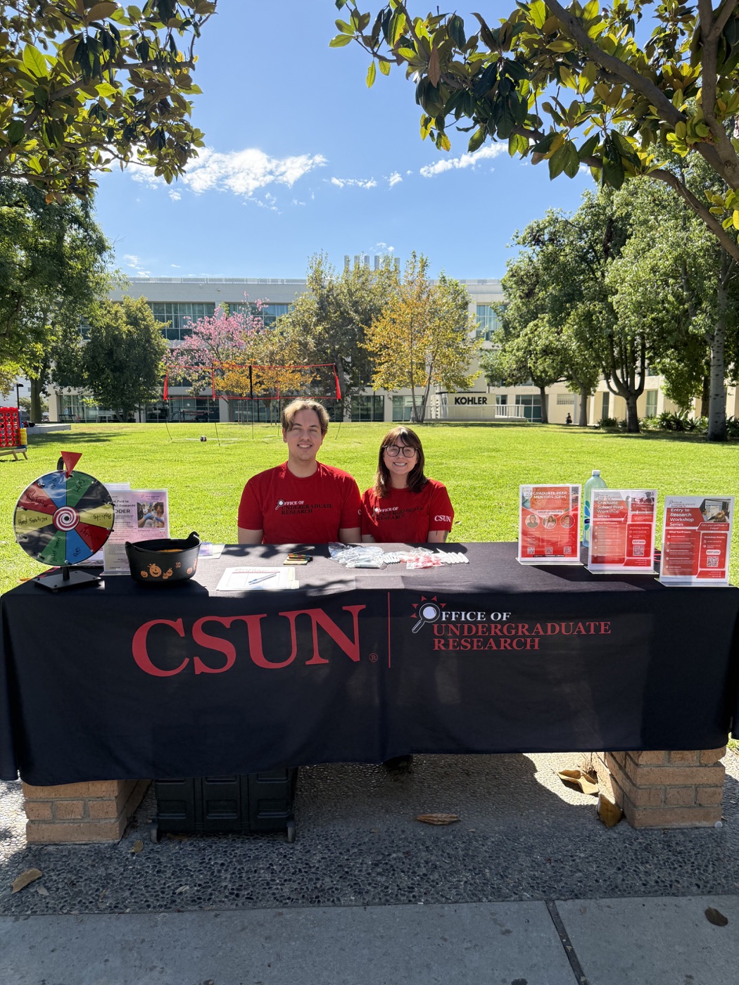 Austin staffing an Office of Undergraduate Research information table on campus